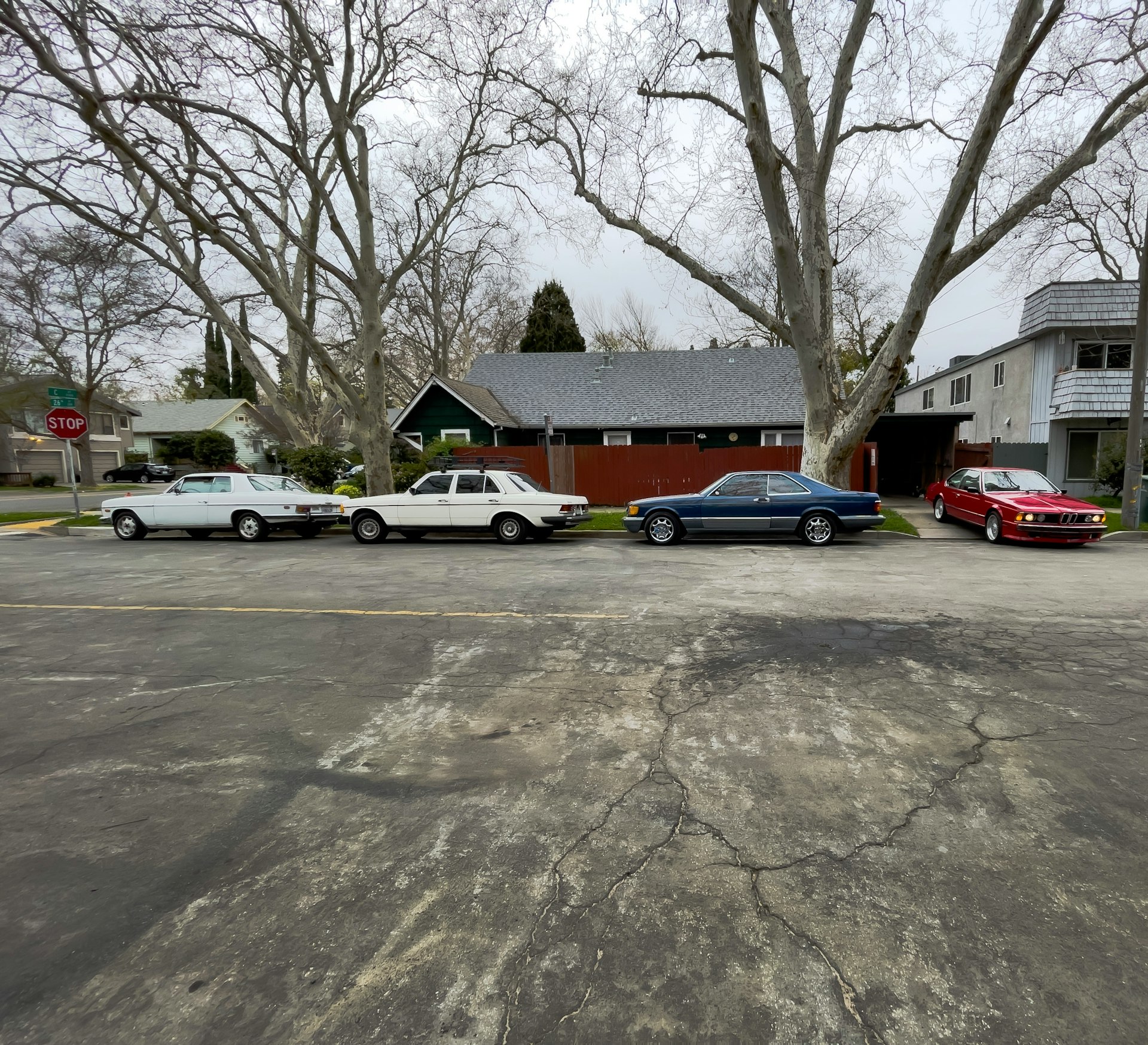 blue sedan parked beside red sedan